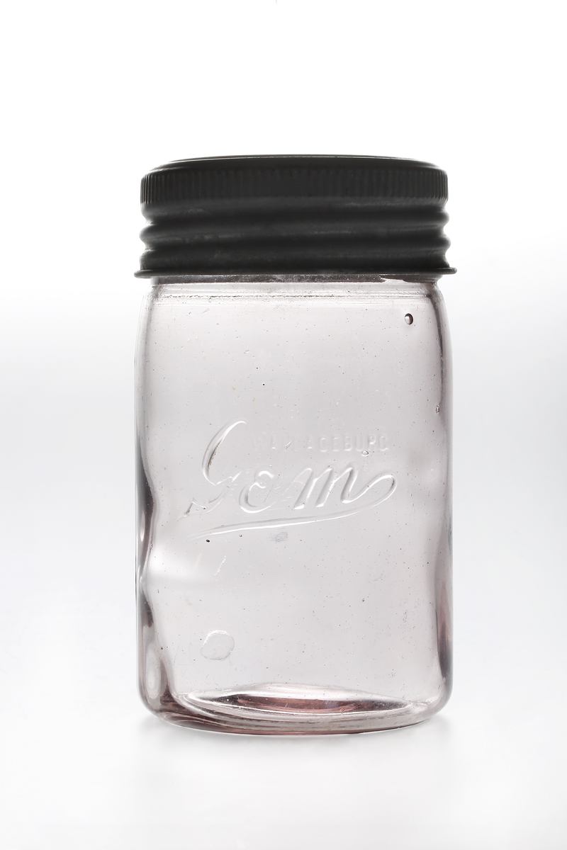 Clear preserving jar with a dark screw lid and raised Gem lettering.