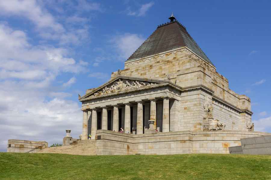 The Shrine’s stepped roof, columned entrance and fixed stone sculptures seen from the lawn.