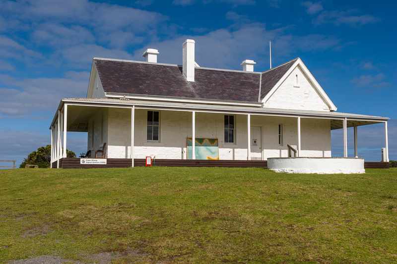 The opposite side of the white telegraph station, with chimneys, veranda and signal-station sign.