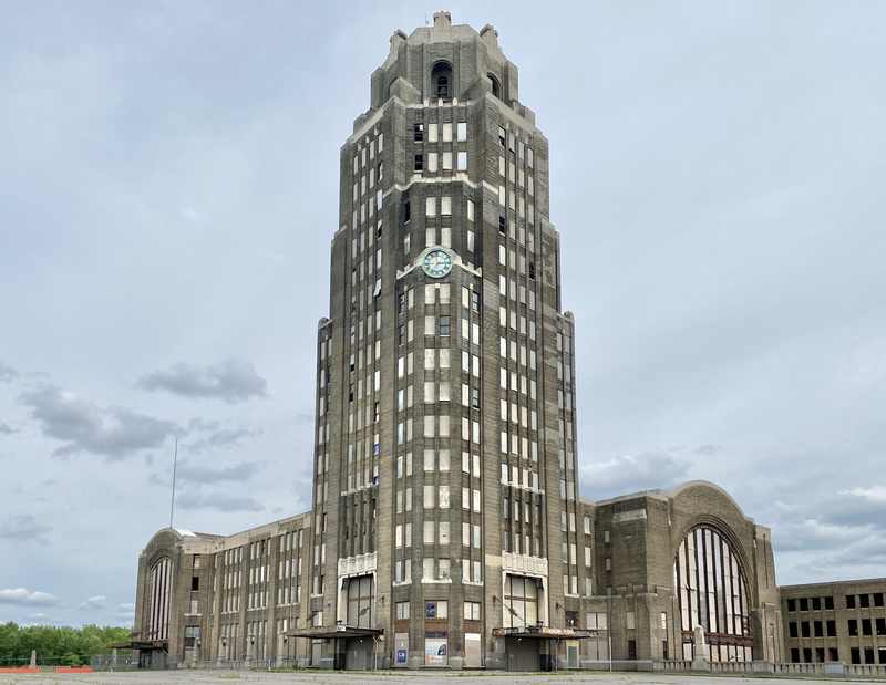 The tall Art Deco terminal tower above lower wings and arched windows, with a clock face mounted high on the tower.